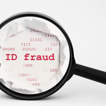 id theft protection service zander magnifying glass over ID fraud on piece of paper 